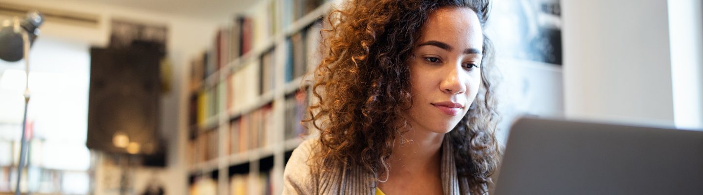 Close up of a student studying on a laptop